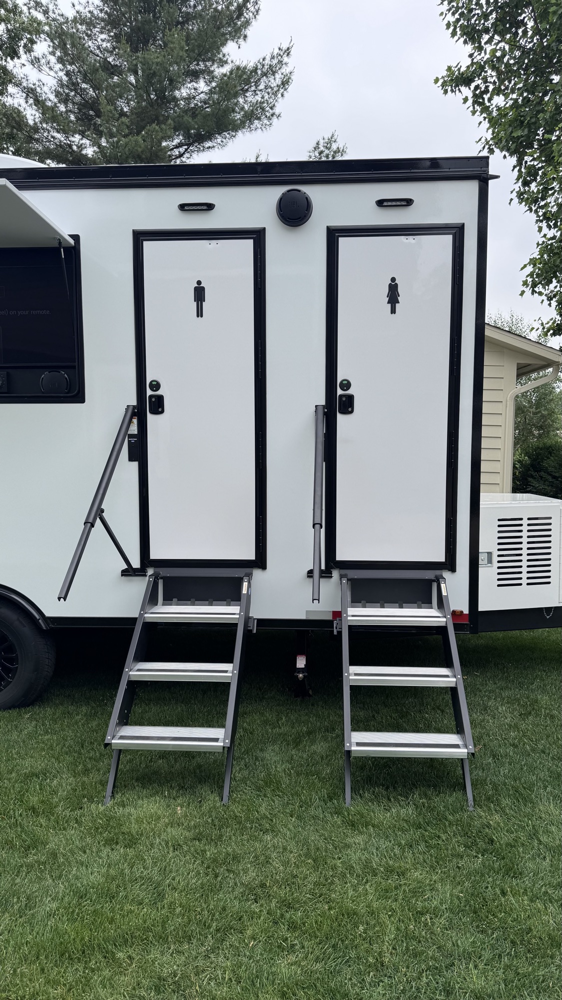 Men's and women's private suite entries with deployed steps on the 4 stall trailer