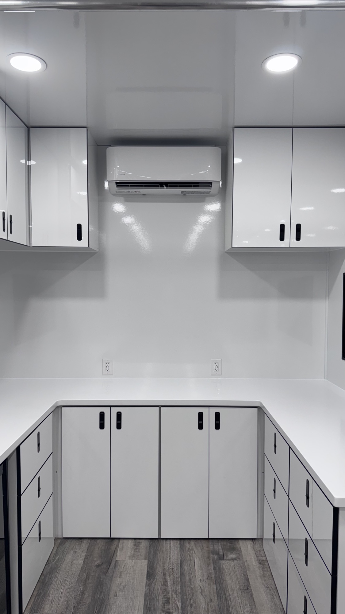 Rear prep area with white quartz counter, drawer banks, upper cabinets, and climate control